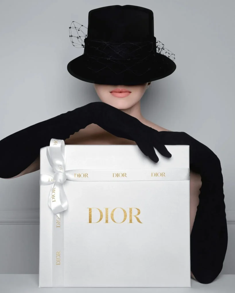 best perfume company in dubai a girl holding a dior perfume box
